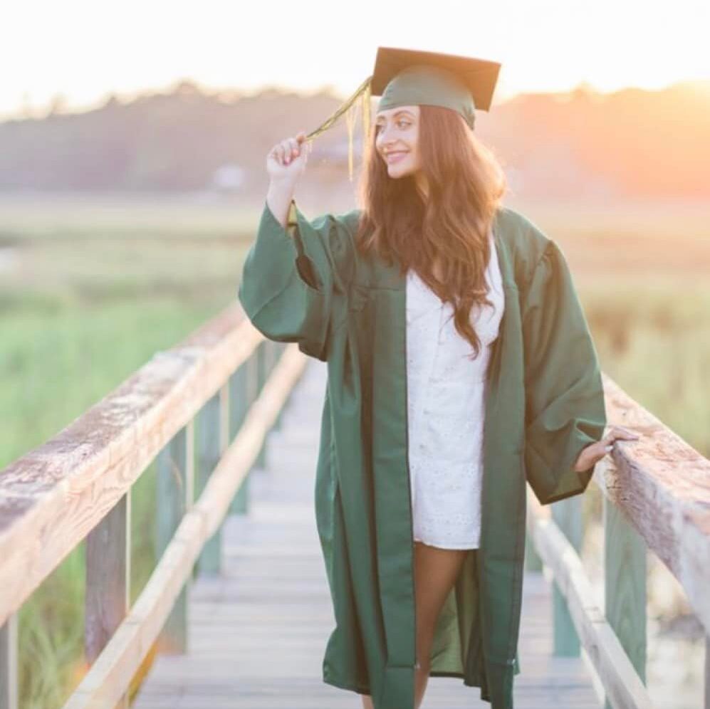 Senior photo session of a girl in her graduation cap and gown 
